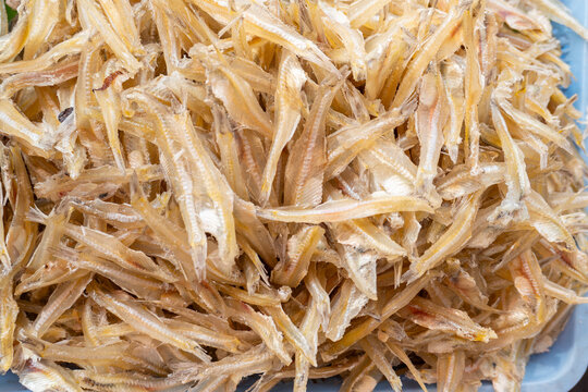 Heap of dried small fish translucent pale yellow seafood for cooking