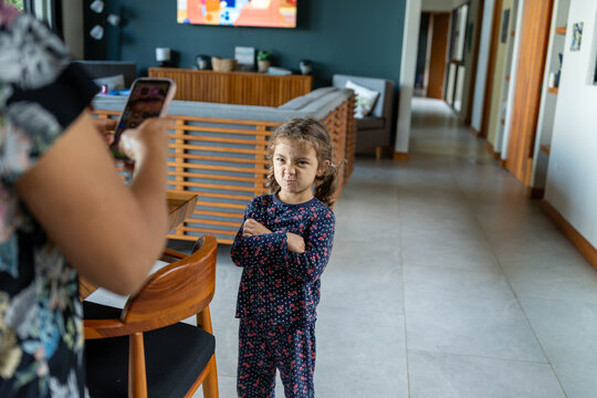 Young girl pouting and folding arms during tantrum