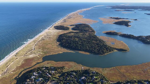 A bird's eye view of Nauset Beach on outer Cape Cod, MA, also shows Pleasant Bay which is connected to the Atlantic Ocean. This scenic area is a popular east coast vacation destination.