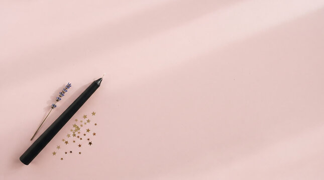 Black taper candle with lavender and gold stars on pink with copy space