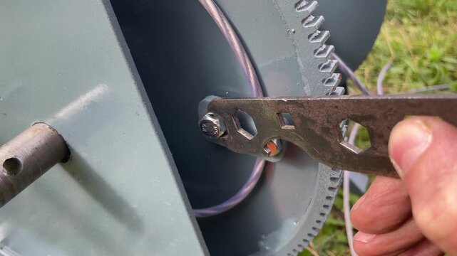 Tightening bolt with wrench on metal winch