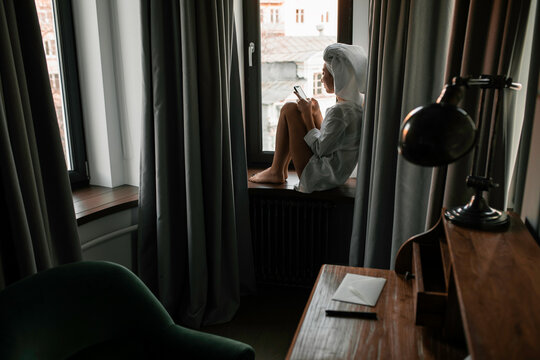 Woman in a hotel room with phone