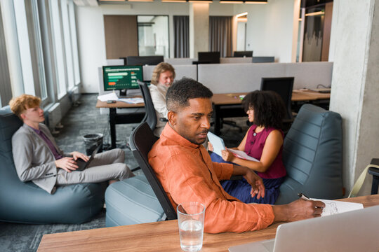 Meeting in a Modern Office With People Working on Tasks