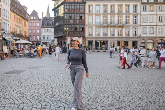Woman exploring historic square in Strasbourg, France