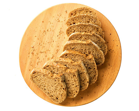 Sliced whole grain buckwheat bread with flax seeds on cutting board , isolated on white background, top view.