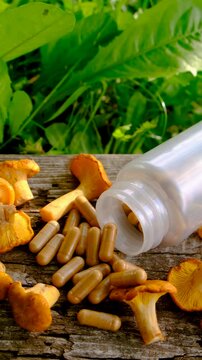 Capsules of chanterelle mushrooms supplements. Selective focus.