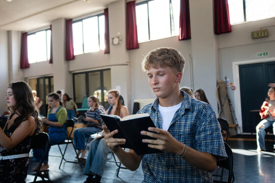Young actor examining his prop book