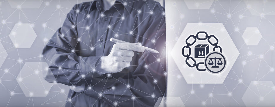 Business person pointing at a legal supply chain graphic with a digital interface, law balance scale icon and networked background for logistics compliance concepts.