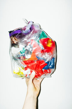 Recycling plastic: transparent bag full of colourful plastic trash