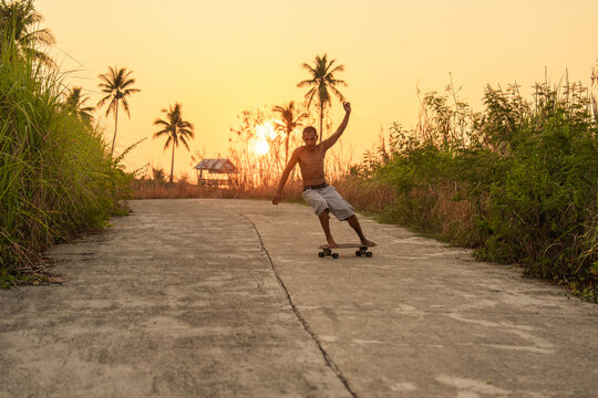 Skateboarding at Sunset Near Palm Trees