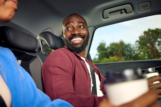Man smiles at a woman sitting next to him in the car