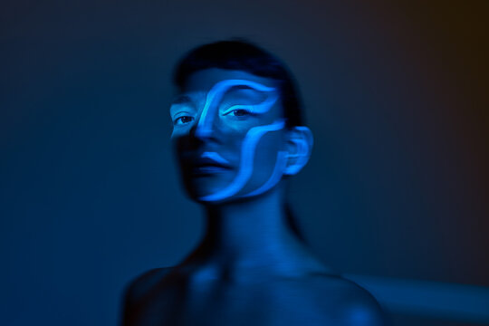 Lighting effects on a person's face in a dark setting