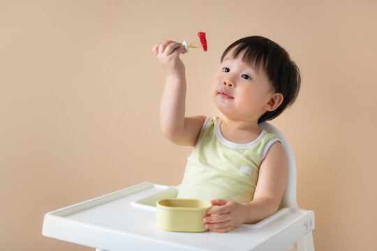 Baby Eating Strawberry on a fork, ready to eat