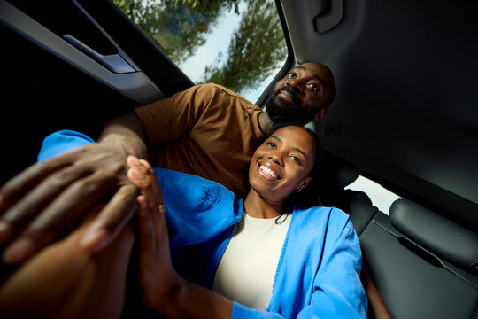 Couple in love travels in the back of a car