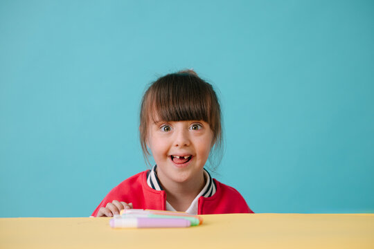 Happy Young Girl with down syndrome Looking at Camera