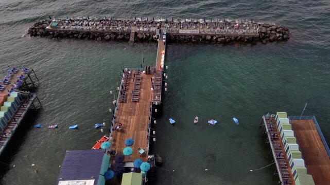 High Angle View from Balcony of Beach Platforms and Pier at Sunset in Sorrento  