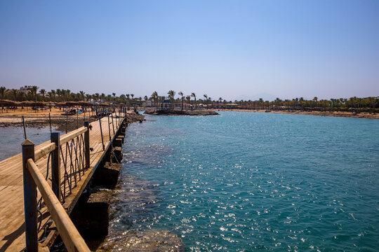 Scenic view of broken and collapsed wooden pier by turquoise sea