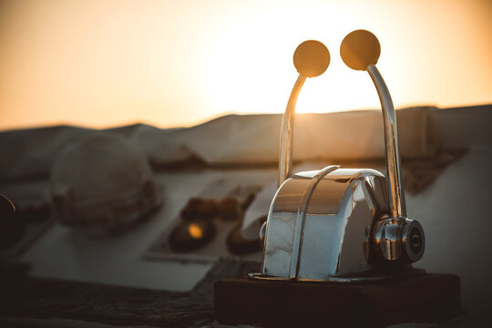 Close up of dual lever marine throttle control on a yacht deck at sunset