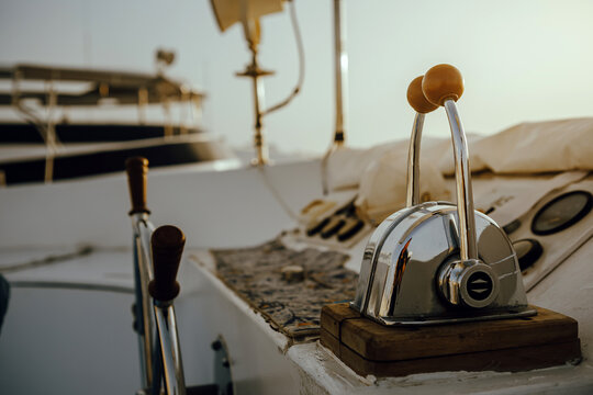 Close up of dual lever marine throttle control on a yacht deck at sunset