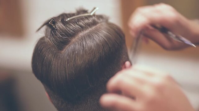 Hairstylist scissors comb cutting male hair closeup. Barbershop haircut salon.