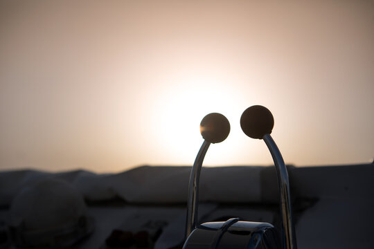 Close up of dual lever marine throttle control on a yacht deck at sunset