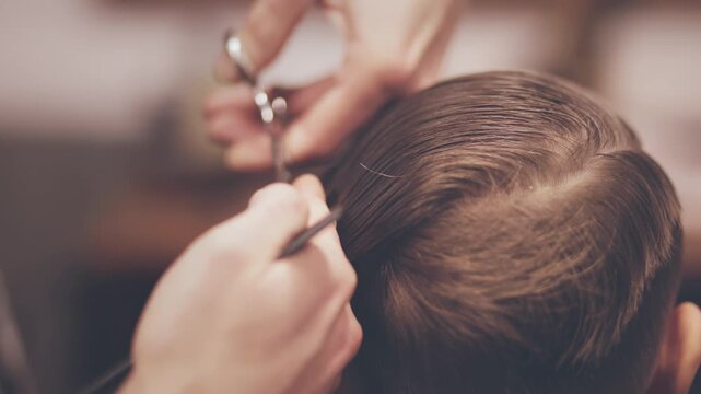 Hairdresser cutting wet hair scissors comb closeup. Male haircut barbershop.