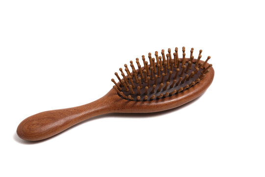 Natural wooden hair brush paddle type angled perspective view isolated on clean white background.