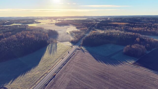 Aerial view of rural autumn morning landscape with frost in Finland with a road