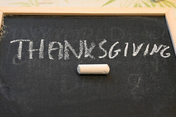 Thanksgiving written in white chalk on a blackboard © Veronika