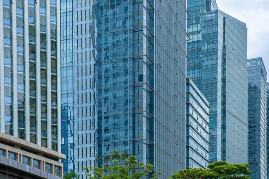 Abstract architecture background of modern office buildings with glass facades, windows and vertical lines in Shenzhen city, China. Geometric texture, minimal design, urban pattern