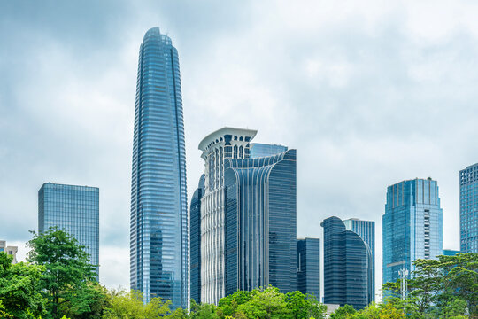 Shenzhen city skyline with modern buildings, glass skyscrapers and green trees, China. Financial district, business architecture, commercial real estate, metropolitan growth, technology economy