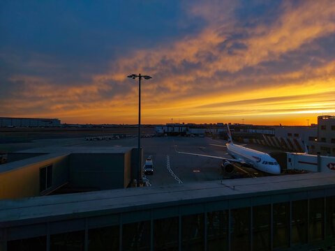 Travel and History: British Airways Passenger Jet Parked at Gate During Dramatic Golden Sunset at London Heathrow Airport