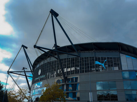 Sports and Architecture: Exterior View of Etihad Stadium Home of Manchester City FC Under Blue Sky in Manchester England