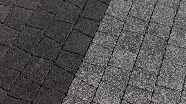 Concrete paving stones arranged in contrasting sections on pedestrian walkway