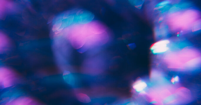 Blur kaleidoscopic. Prism crystal leak. Round neon flare on violet blue purple background. Colorful abstract fluorescent refraction.