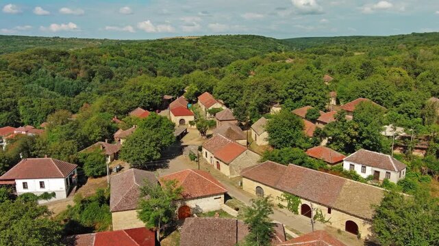 Aerial around view of old rustic vintage houses with wine cellars in Rogljevacke pivnice in Negotin region of Serbia, 4k