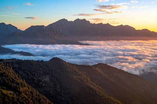 A view of the valleys and mountains of the Picos de Europa, bathed in the colours of dawn, from the Collado de Llesba viewpoint in Cantabria, Spain