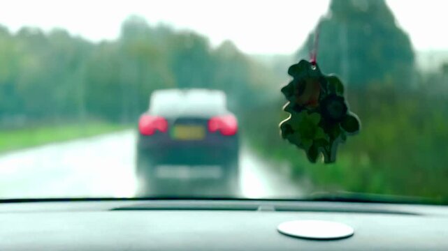 driving during rain with active windscreen wipers and hanging air freshener