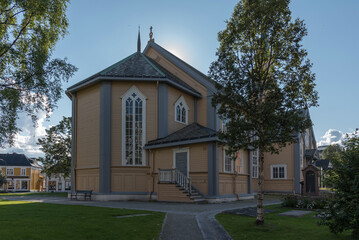 Traditional wooden Tromso Cathedral (Tromso domkirke) under blue sky in downtown Tromso, Northern Norway © LAURA