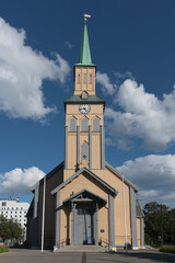 Traditional wooden Tromso Cathedral (Tromso domkirke) under blue sky in downtown Tromso, Northern Norway © LAURA