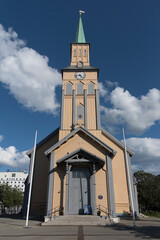 Traditional wooden Tromso Cathedral (Tromso domkirke) under blue sky in downtown Tromso, Northern Norway © LAURA