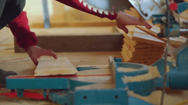 Sawing wood, working with a saw, a saw in house construction, sawing a board