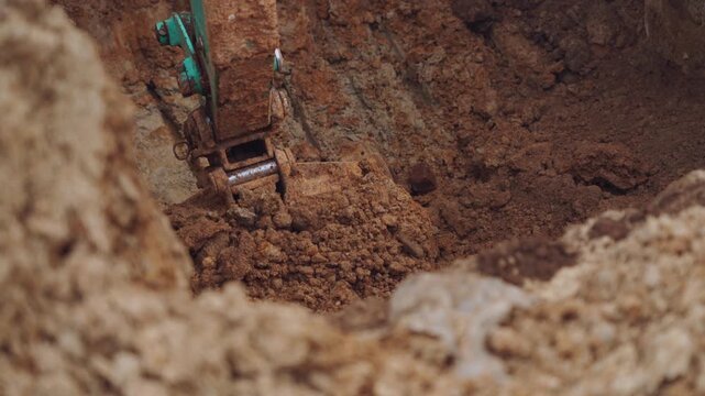 Excavator operation, the excavator is digging the ground, the excavator is excavating the ground