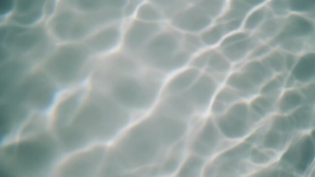 Abstract seamless loop of white water caustics or bright sun reflections dancing on a clean white pool or liquid surface for a bright and minimal backdrop