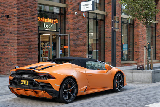 Orange Lamborghini Huracan Evo Spyder parked outside Sainsbury's Local