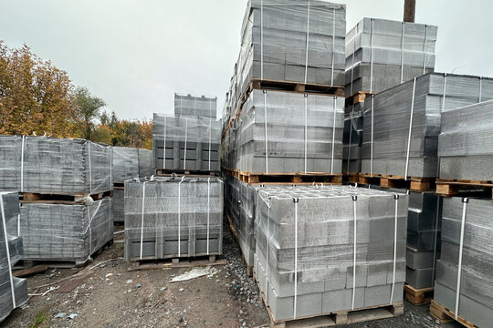 Outdoor storage warehouse with stacked concrete block pallets