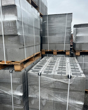 Vertical view of stacked and wrapped concrete block pallets