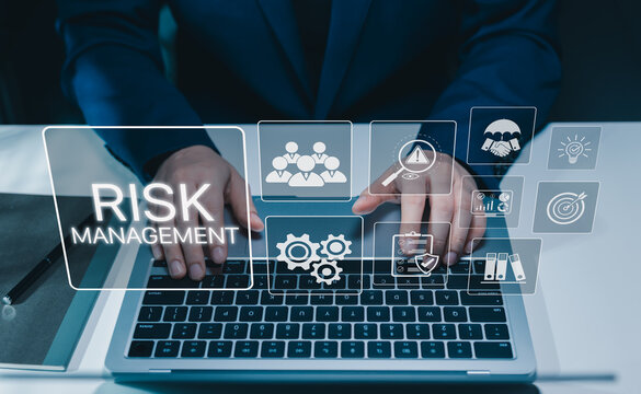 Risk management and business resilience concept. Businessman using laptop and assessment interface, risk analysis, compliance, internal controls, mitigation planning, governance, operational security