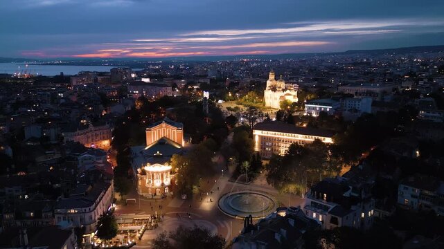 Aerial view of Varna drama theater and cathedral illuminated at dusk, Bulgaria