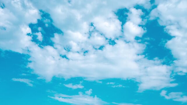 Fast Moving White Clouds Timelapse Across Bright Blue Sky, Changing Weather Patterns and Dynamic Cloudscape with Sunlit Cloud Formations.